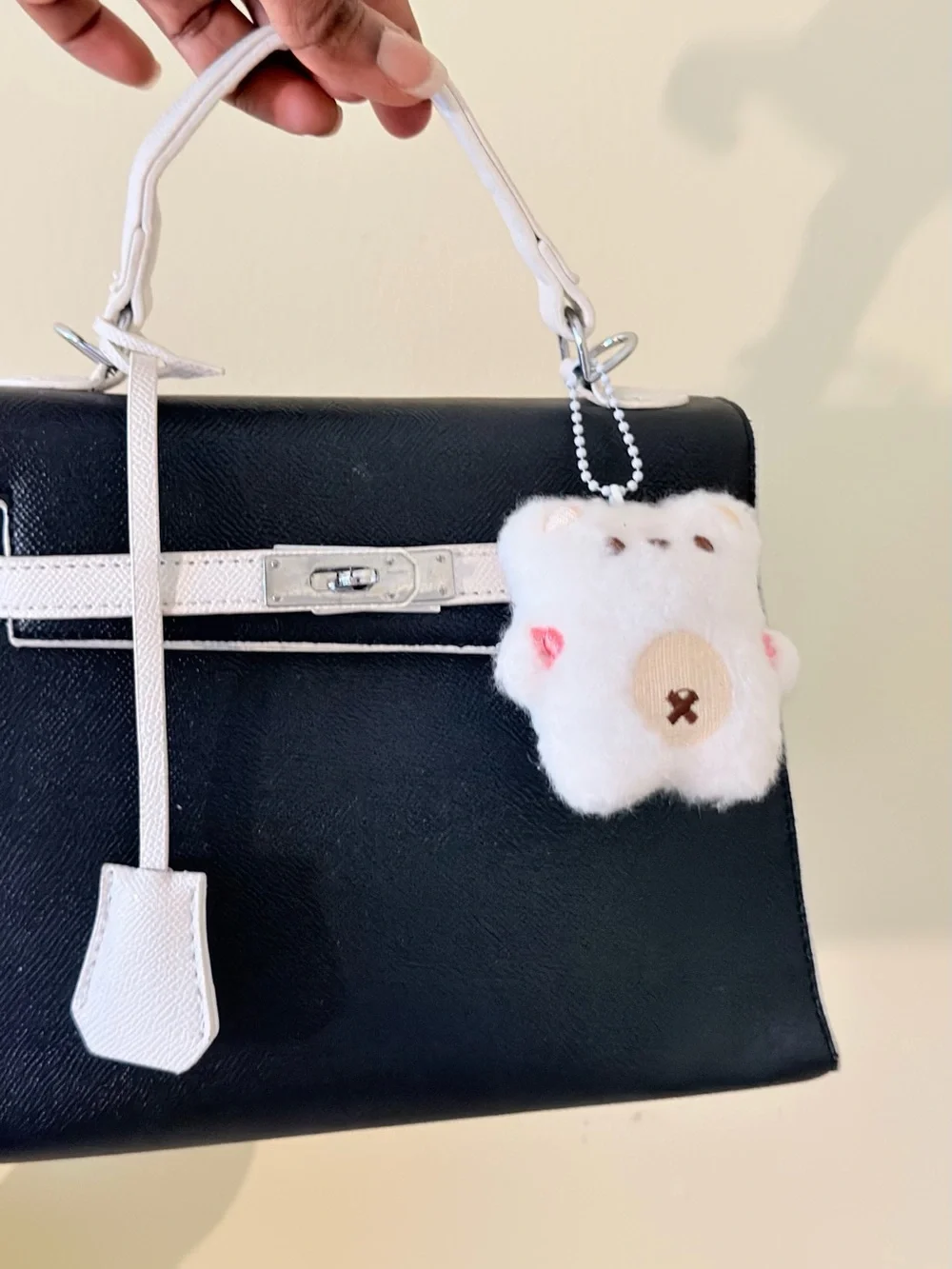Black and White Structured Top-Handle Bag with Plush Charm